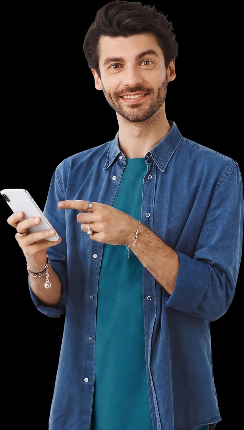 A smiling oleh in a denim shirt pointing at the phone in his hand